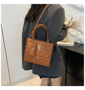 Brown quilted crossbody handbag with triangular stitching and small companion purse