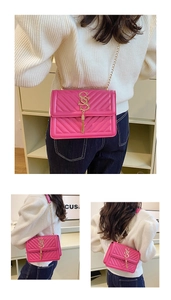 Detail view of pink quilted bag with gold S-logo, chain strap and elegant tassel pendant