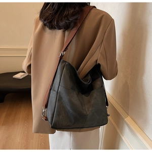 Detailed view of the large charcoal tote bag with adjustable brown wide shoulder strap