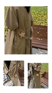 Mini star crossbody bag with gold rhinestones shown on model in autumn park setting
