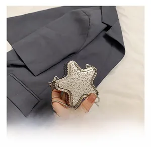 Close-up of star-shaped silver acrylic mini bag with shimmering rhinestone embellishments