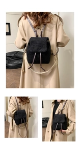 Detail of black fleece backpack with brown leather drawstrings and shoulder straps