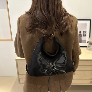 Vintage black butterfly suede backpack with lace-up detail and adjustable straps for women