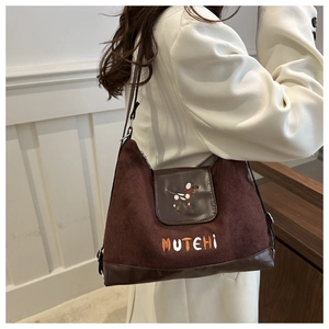 Detail of caramel brown matte shoulder bag featuring cute dog and MUTEHI embroidery