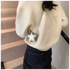Détail du mini sac boîte en forme d'étoile avec clous argentés et chaîne métal