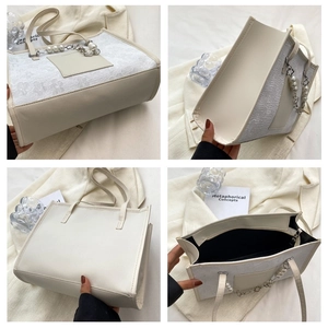 Detail view showing floral lace texture, pearl chain handle and bag interior structure