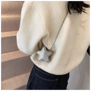 Detailed view of a silver star-shaped mini crossbody bag with sparkling rhinestones and chain