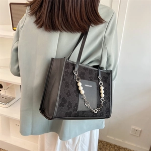 Fashionable black floral jacquard tote bag with elegant pearl chain and shoulder strap