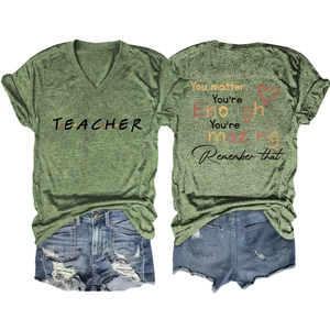 Detail of teacher slogan print on moss green V-neck tee with denim shorts back view