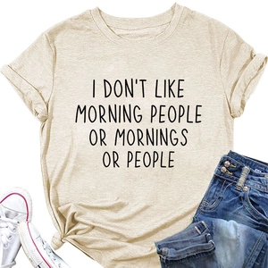 Close-up of Apricot t-shirt with I Don't Like Morning slogan text and denim jeans