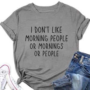 Flat lay of gray cotton t-shirt with slogan, paired with denim shorts and white sneakers