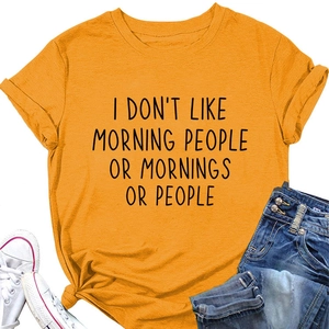 Detail of yellow cotton t-shirt featuring I DON'T LIKE MORNING slogan with flat lay styling
