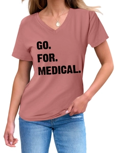 Close-up of a dusty pink V-neck T-shirt with GO FOR MEDICAL printed text on the chest