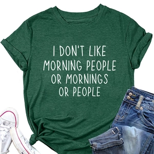 Flat lay of green round neck T-shirt with rolled sleeves and funny morning quote print