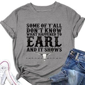 Flat lay of gray graphic t-shirt with bull skull print and casual denim accessories