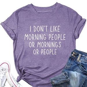 Flat lay of purple short sleeve t-shirt with slogan, denim shorts and sneakers