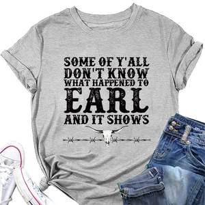 Flat lay of gray T-shirt with bull skull graphic and American slogan paired with jeans