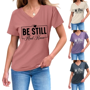 Detail of V-neck short sleeve T-shirt with BE STILL AND KNOW heart print in multiple colors