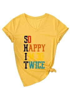 Detail of V-neck yellow T-shirt with 'So Happy I'm 30 Twice' text and knotted hem decor