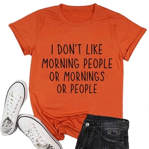 Detail of casual orange cotton T-shirt with black text print paired with denim shorts