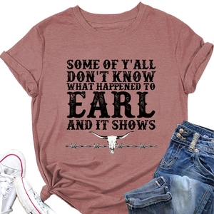 Flat lay of a brick red t-shirt with bull skull print, denim shorts and sneakers