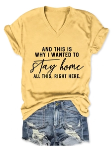 Flat lay of a yellow V-neck T-shirt with black slogan print and frayed denim shorts