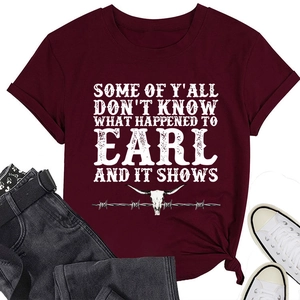 Close-up of burgundy t-shirt with longhorn skull graphic and white retro typography
