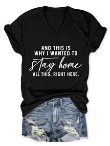 Flat lay of a black V-neck t-shirt with white slogan print and distressed denim shorts