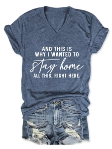 Flat lay of navy V-neck slogan T-shirt paired with distressed denim shorts on white background