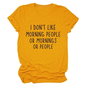 Detail of loose fit ginger yellow crew neck tee with black text print on cotton fabric