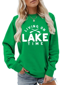 Detail of green sweatshirt with Living On Lake Time text and oar graphics