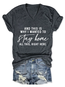 Flat lay detail of a grey V-neck T-shirt with white text and ripped denim shorts