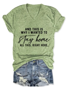 Detailed flat lay of a green V-neck t-shirt with slogan and distressed denim shorts