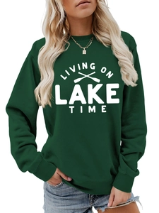 Detail of dark green sweatshirt featuring white Living On Lake Time print and oars graphic