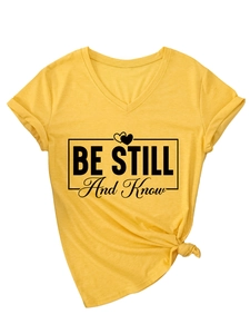 Detail of V-neck mustard T-shirt with rolled sleeves and a stylish front-tie knotted hem