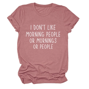 Close-up of I Don't Like Morning People slogan print on pink cotton T-shirt fabric