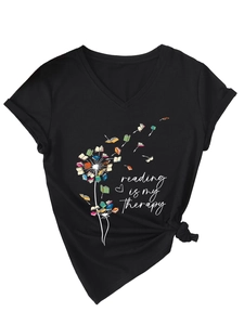 Détail du t-shirt noir à col en V avec imprimé pissenlit-livre et ourlet noué élégant