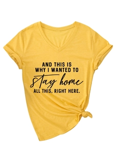 Detail of mustard yellow V-neck tee with black text print and stylish knotted hem