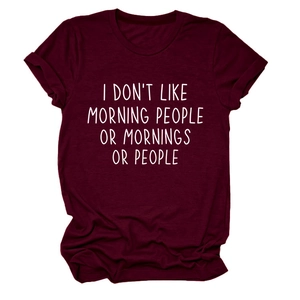 Detail of burgundy t-shirt with I Don't Like Morning slogan and folded cuffs on white background