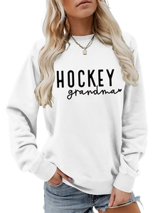 Détail de l'inscription HOCKEY grandma et du motif cœur sur un sweat blanc