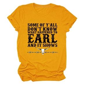 Detailed close-up of mustard yellow t-shirt with bull skull and retro text print