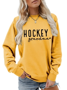Détail de l'imprimé HOCKEY grandma sur le sweat-shirt jaune moutarde à manches longues