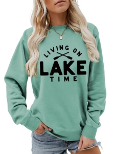 Detail of mint green sweatshirt featuring Living on Lake Time print and ribbed texture