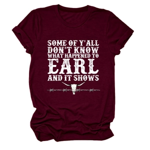 Detail of burgundy T-shirt featuring a white bull skull graphic and vintage typography
