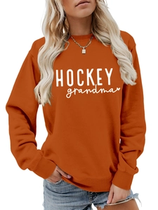 Détail de l'imprimé HOCKEY grandma et du cœur sur ce sweat-shirt orange pour femme
