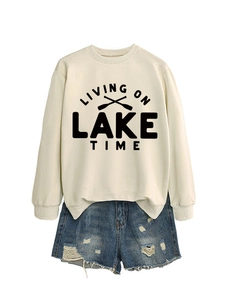 Detail of off-white sweatshirt with Lake Time print and distressed denim shorts