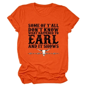 Detail of orange t-shirt showing cow skull graphic and vintage American slogan print