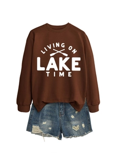 Brown sweatshirt with Living on Lake Time print paired with distressed denim shorts