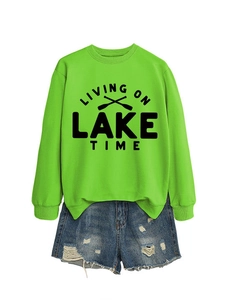 Detail of green Lake Time sweatshirt with crossed paddles print and ripped denim shorts