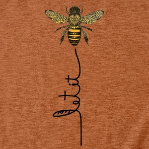 Detail of bee print with mandala patterns and Let It Bee text on caramel t-shirt